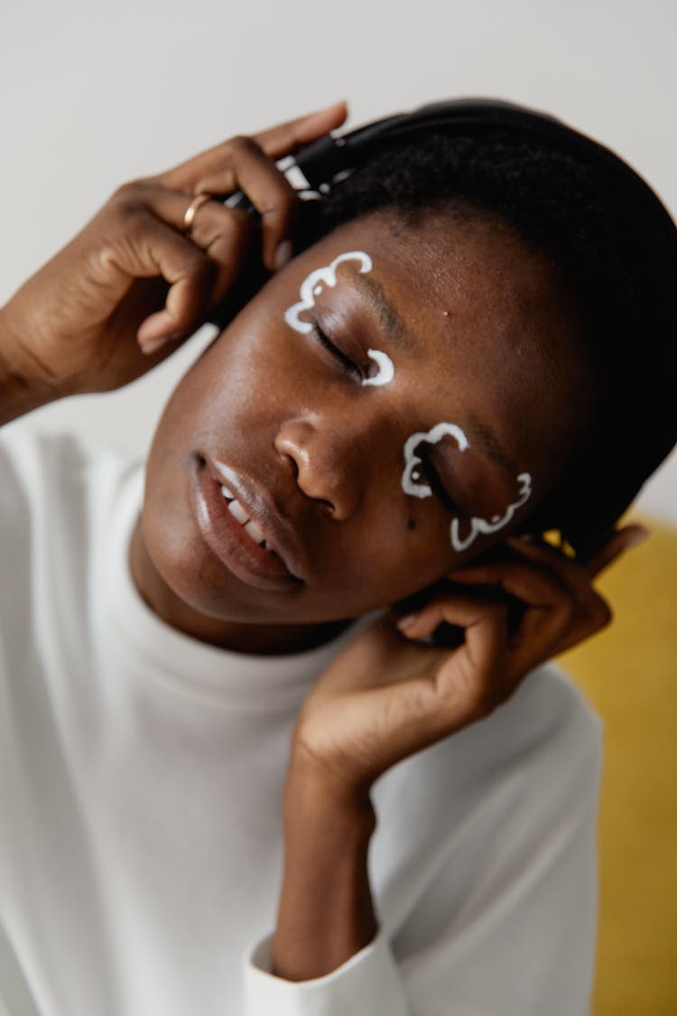 A Woman With Eyes Closed Listening To Music On A Headphone