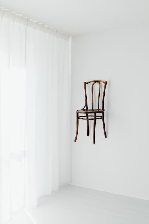 Brown Wooden Chair Hanging on White Wall 