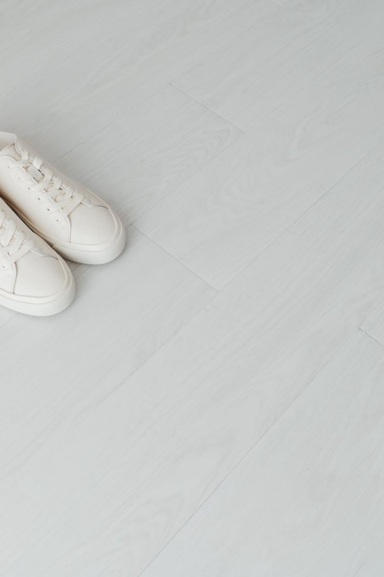 White Sneakers On Light Gray Floor Panels 