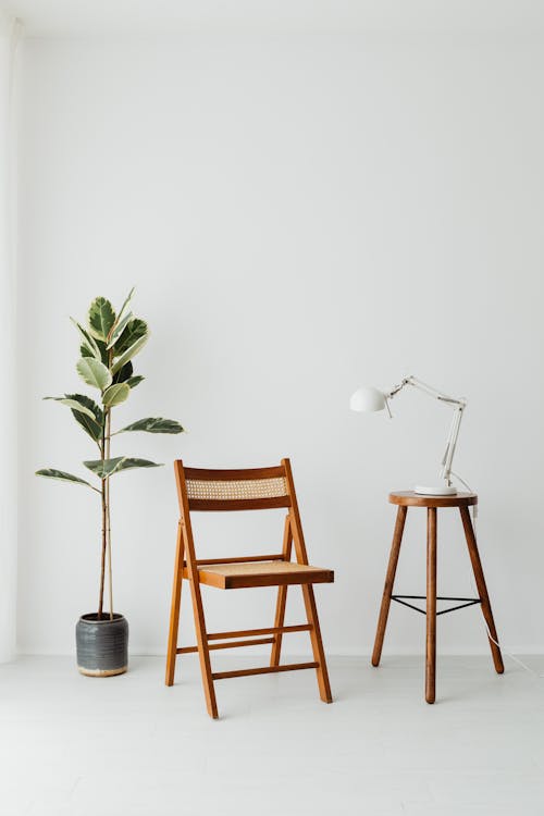 Free Brown Wooden Chair Between Potted Green Plant and Stool Stock Photo