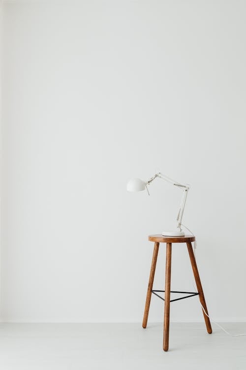 White Desk Lamp on a Wooden Bar Stool