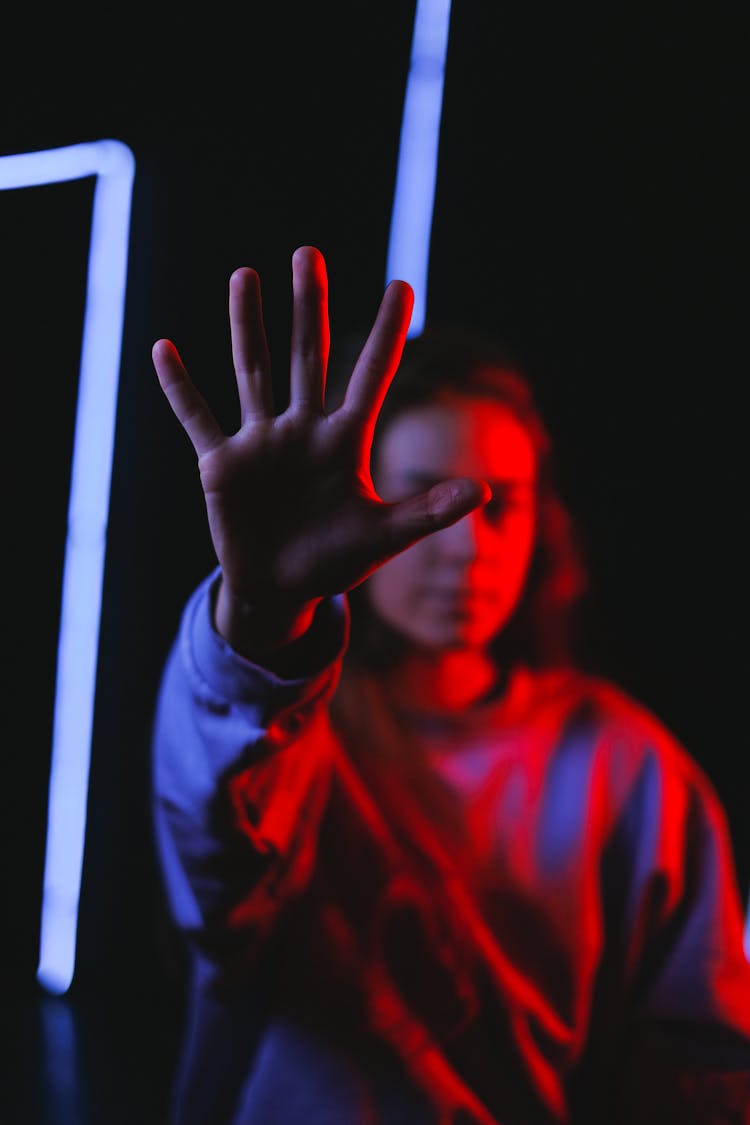 Female Reaching Out Hand In Dark Room