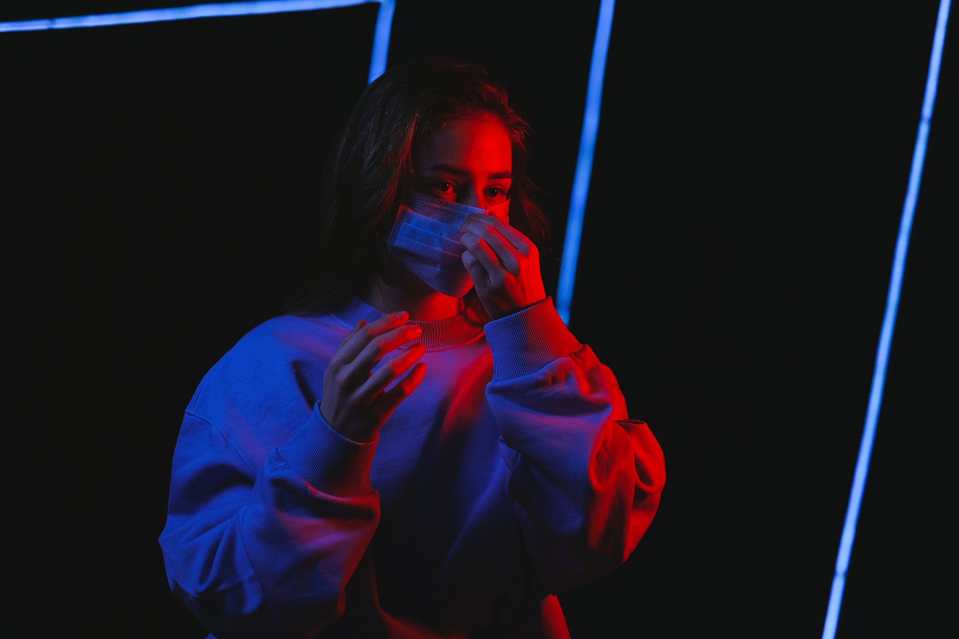person lying in bed wearing a CPAP mask with soft blue lighting and a calm bedroom environment