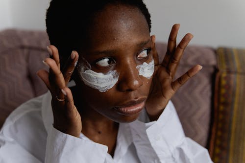 Woman Touching her Face with Under Eye White Paint