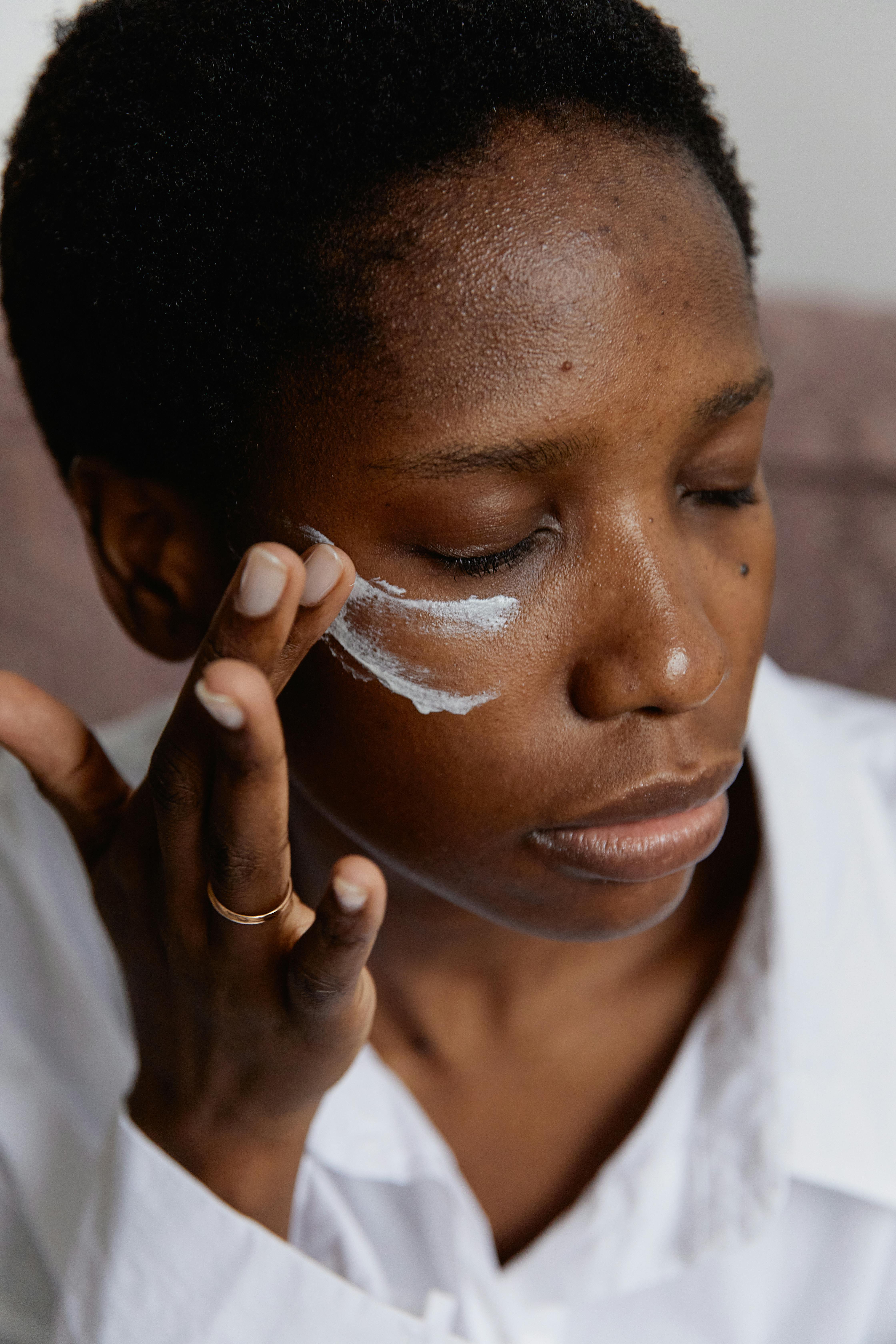Close-up of woman applying white paint … – License image – 10171462 ❘ Image  Professionals