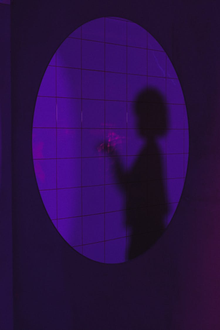 Shadow Of Woman On Purple Wall