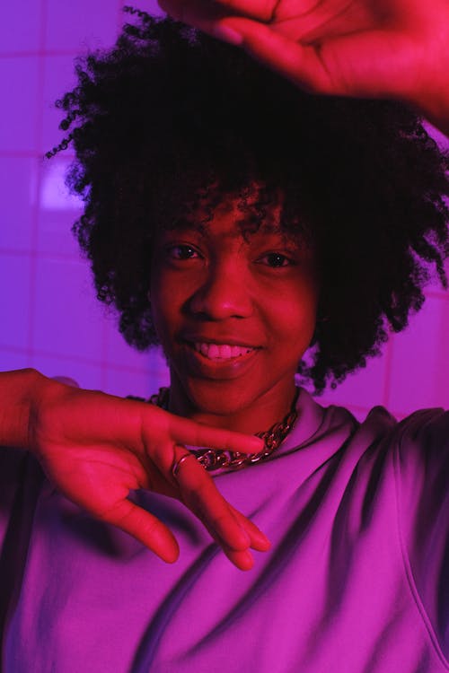 Cool black teen with Afro hairstyle in neon light