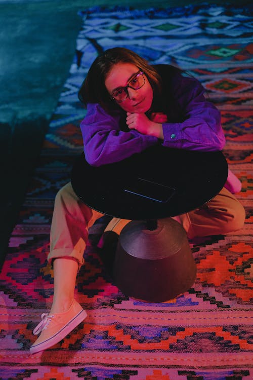 Woman leaning on round table