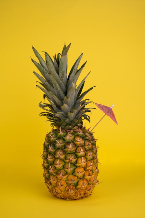 Whole pineapple with cocktail umbrella