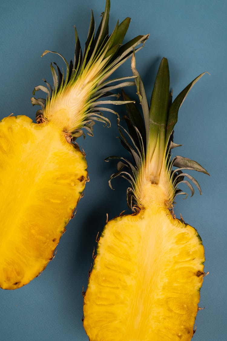 Cut Ripe Pineapple With Sweet Flesh And Green Leaves