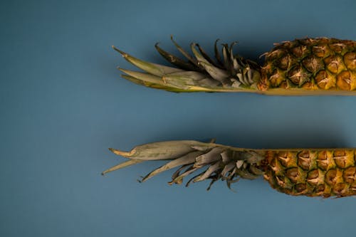Backdrop of fresh cut pineapple with wavy leaves