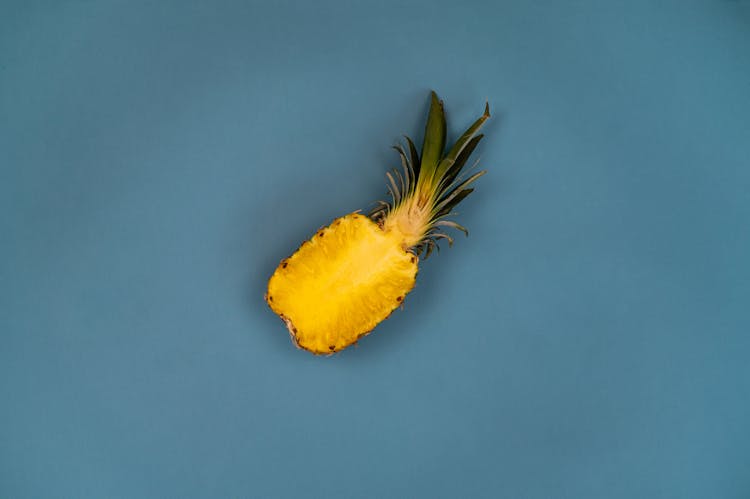 Ripe Pineapple Half With Sweet Flesh And Wavy Leaves