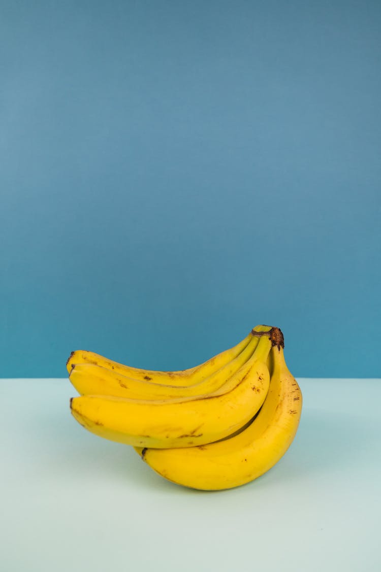 Bundle Of Fresh Bananas On Two Color Background