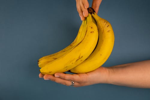 Faceless woman with bunch of delicious bananas