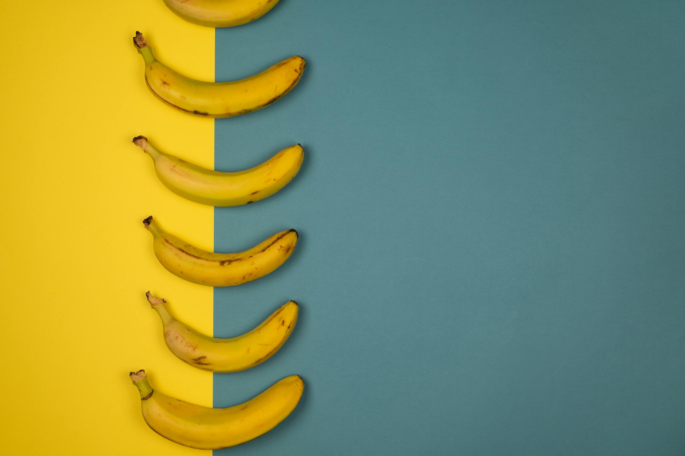 bananas with teal and yellow background