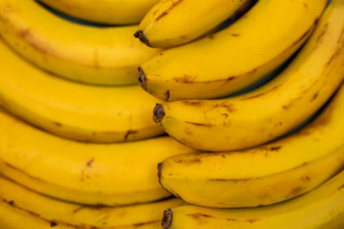 Background of ripe bananas with blots on peel