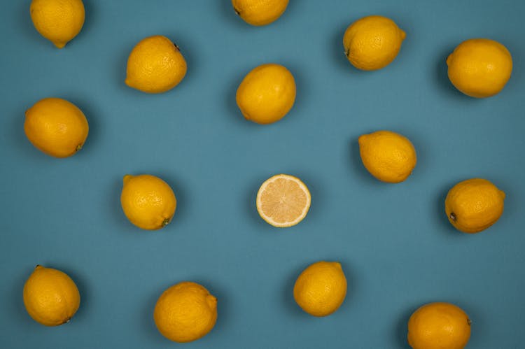 Fresh Lemons With Juicy Flesh On Blue Background