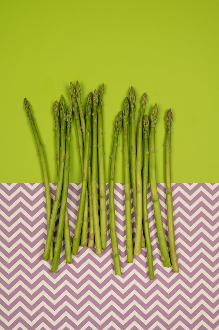 Fresh Asparagus Stems On Two Color Background