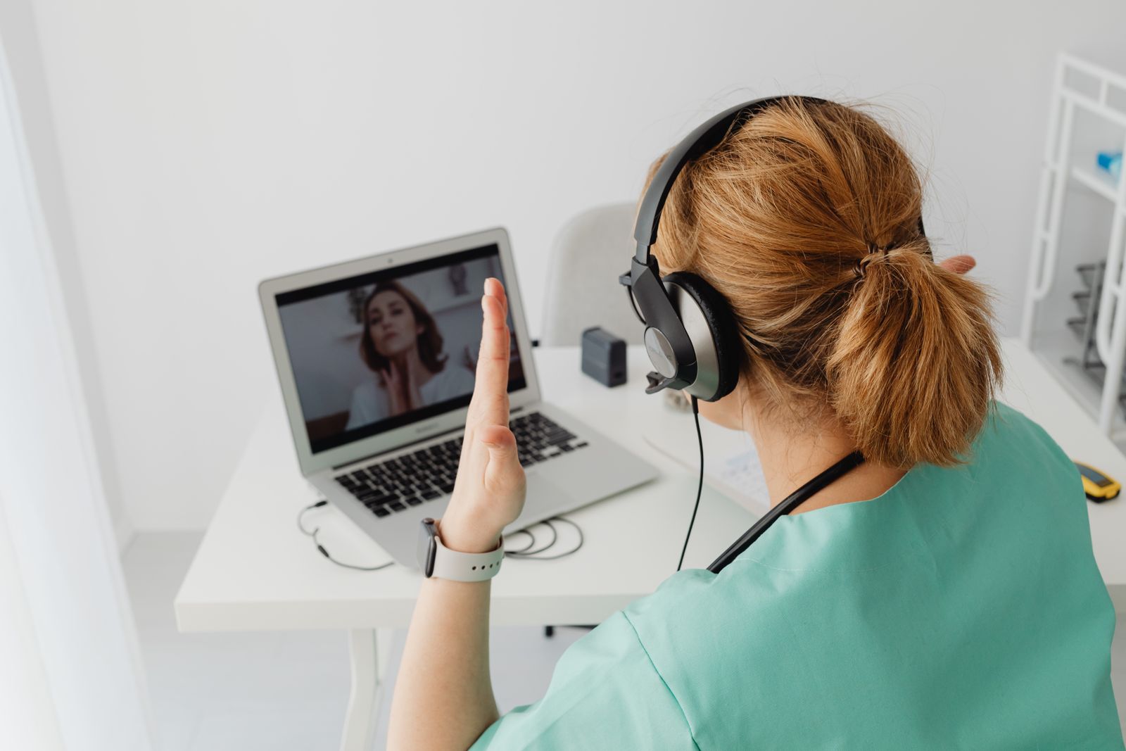 A clinician greeting a patient during a telehealth video visit