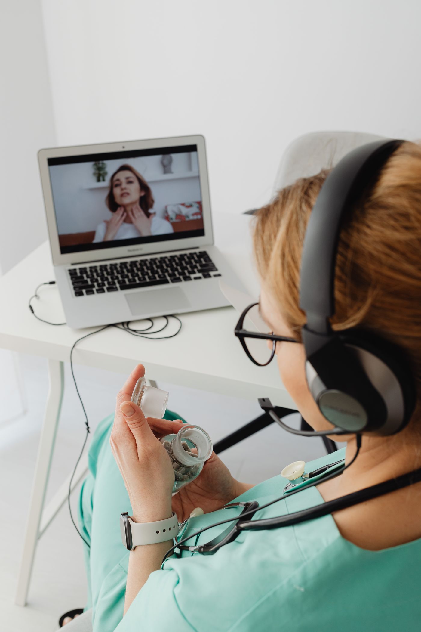 Doctor conducting a private telehealth video consultation on a laptop