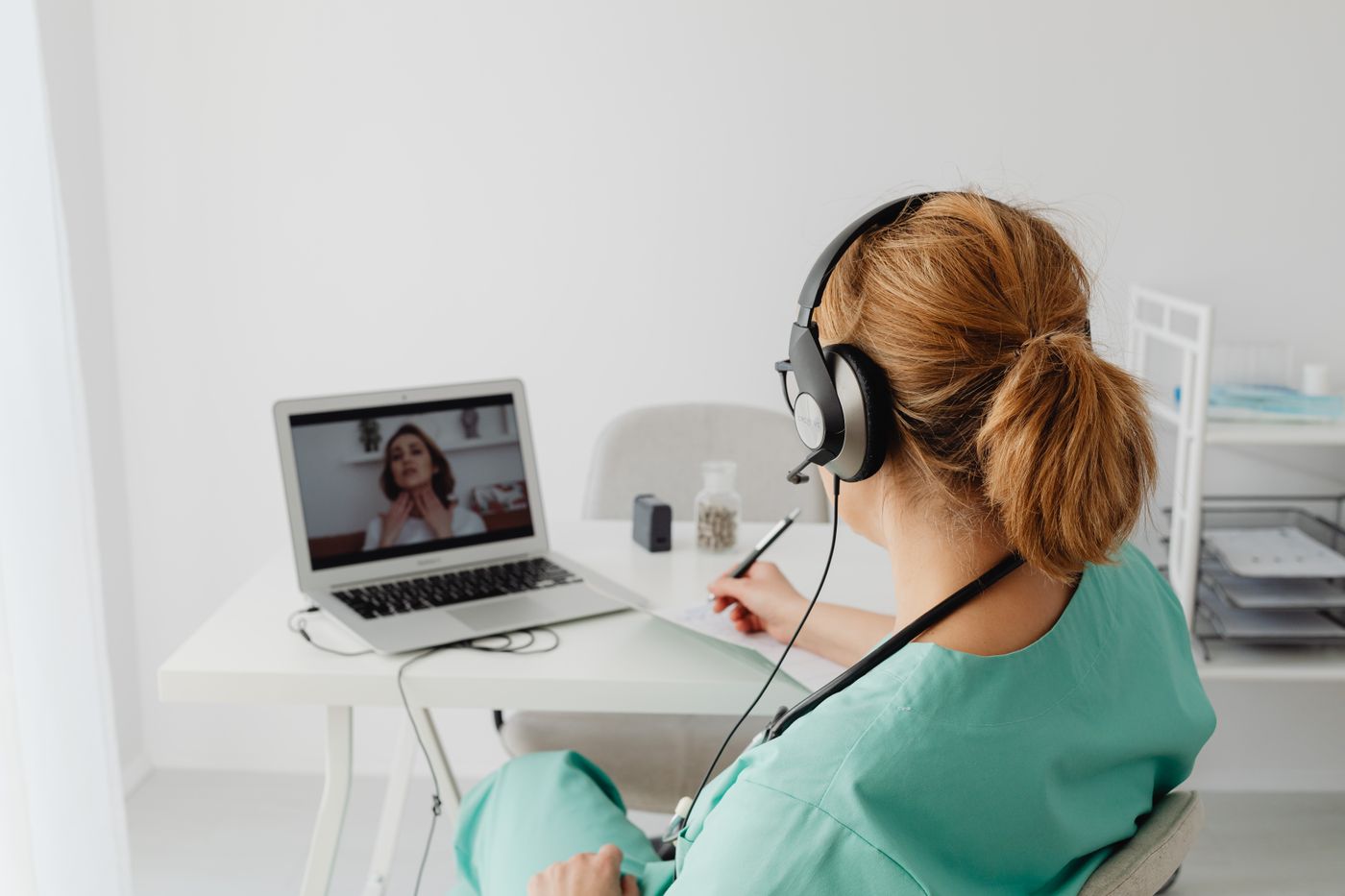 Healthcare professional conducting a virtual psychiatric consultation using a laptop
