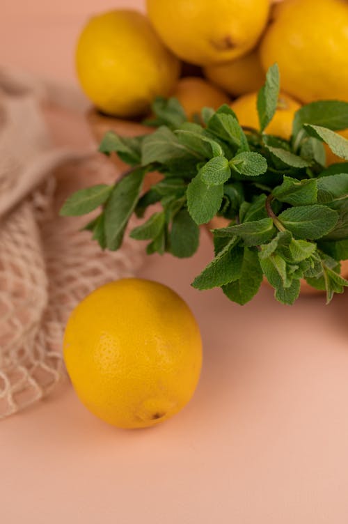 Yellow Citrus Fruit on Pink Surface