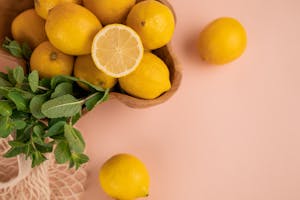 Fresh lemons and mint sprigs above zero waste bag
