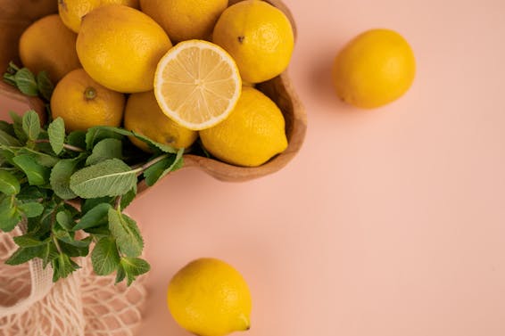 Fresh lemons and mint sprigs above zero waste bag