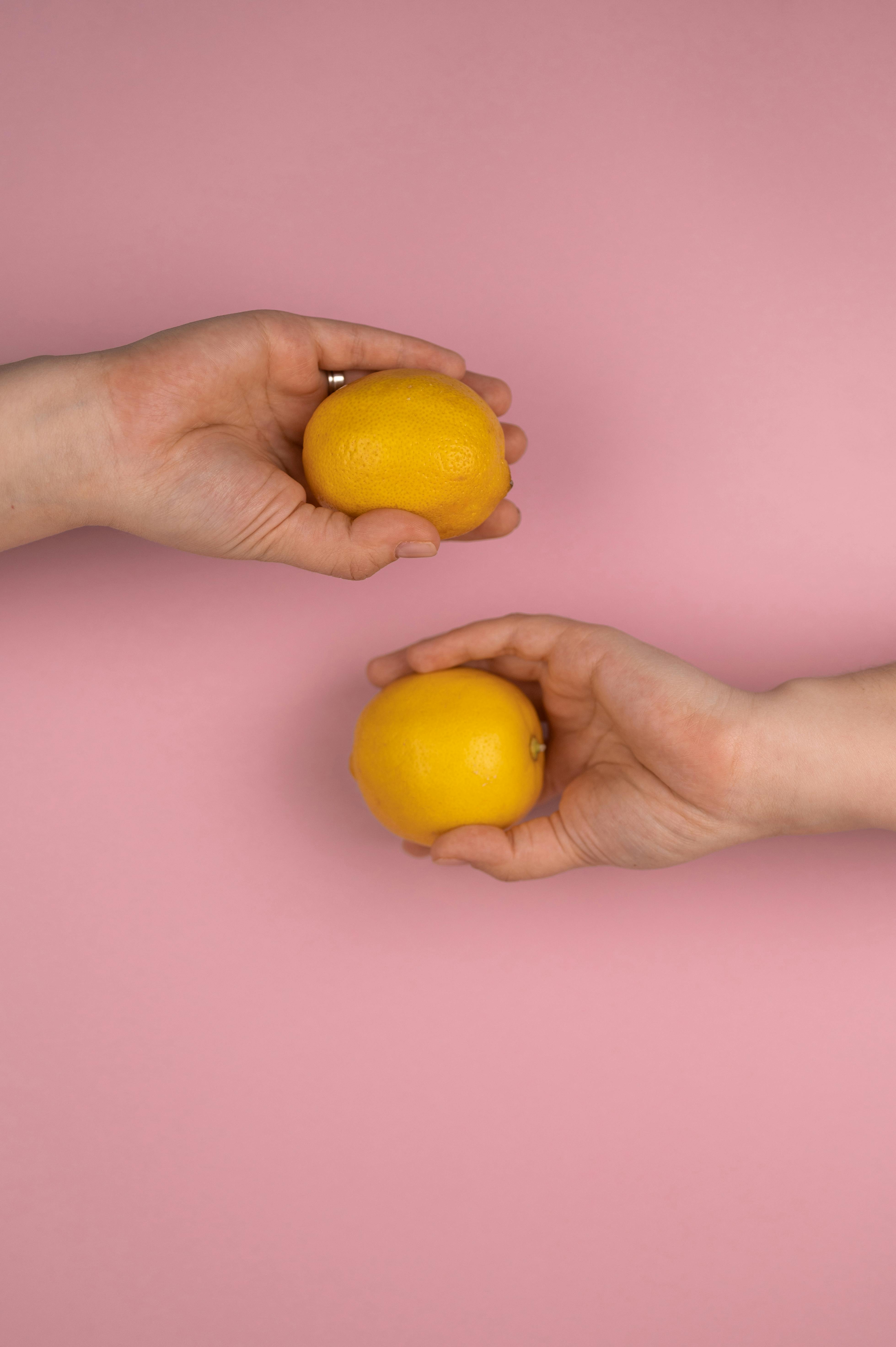 crop person with yellow lemons