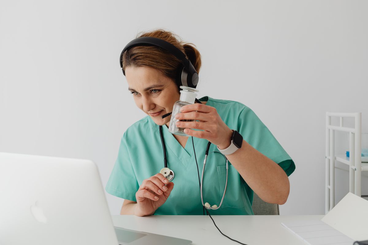 Nurse reviewing prescription medication during an online consultation