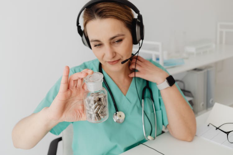 Woman Holding Bottle With Pills