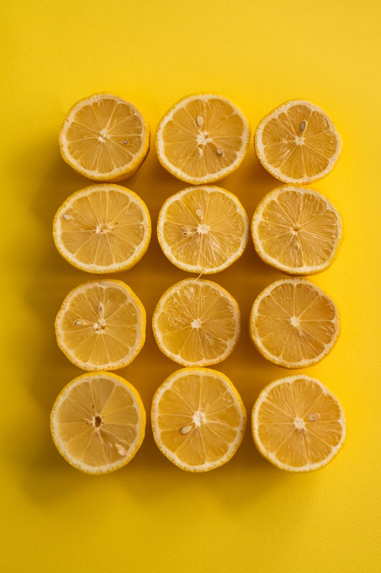 Sliced Lemons On Yellow Background