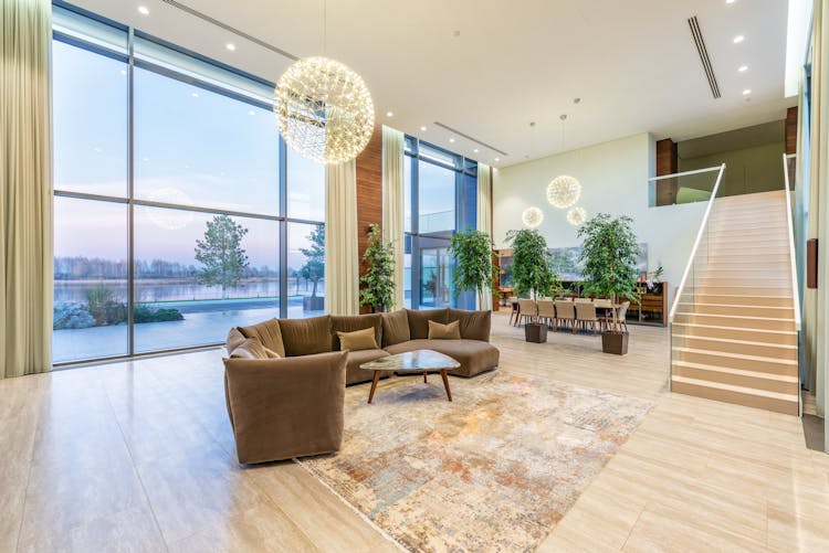 Spacious Lobby With Sofa Near Stairs And Glass Transparent Wall