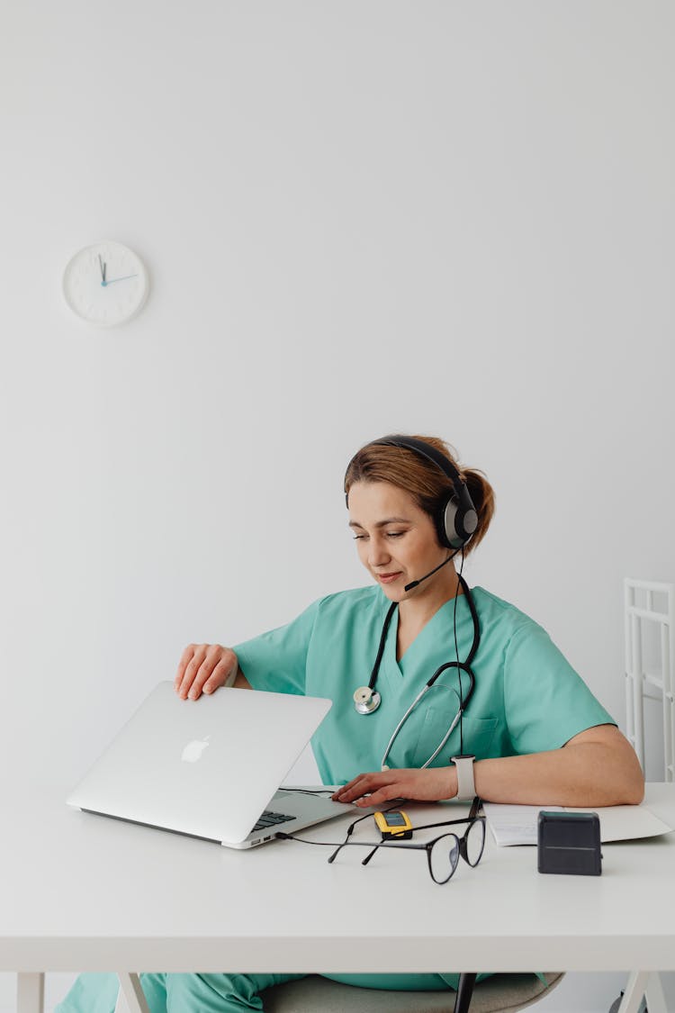 A Female Doctor Using A Laptop