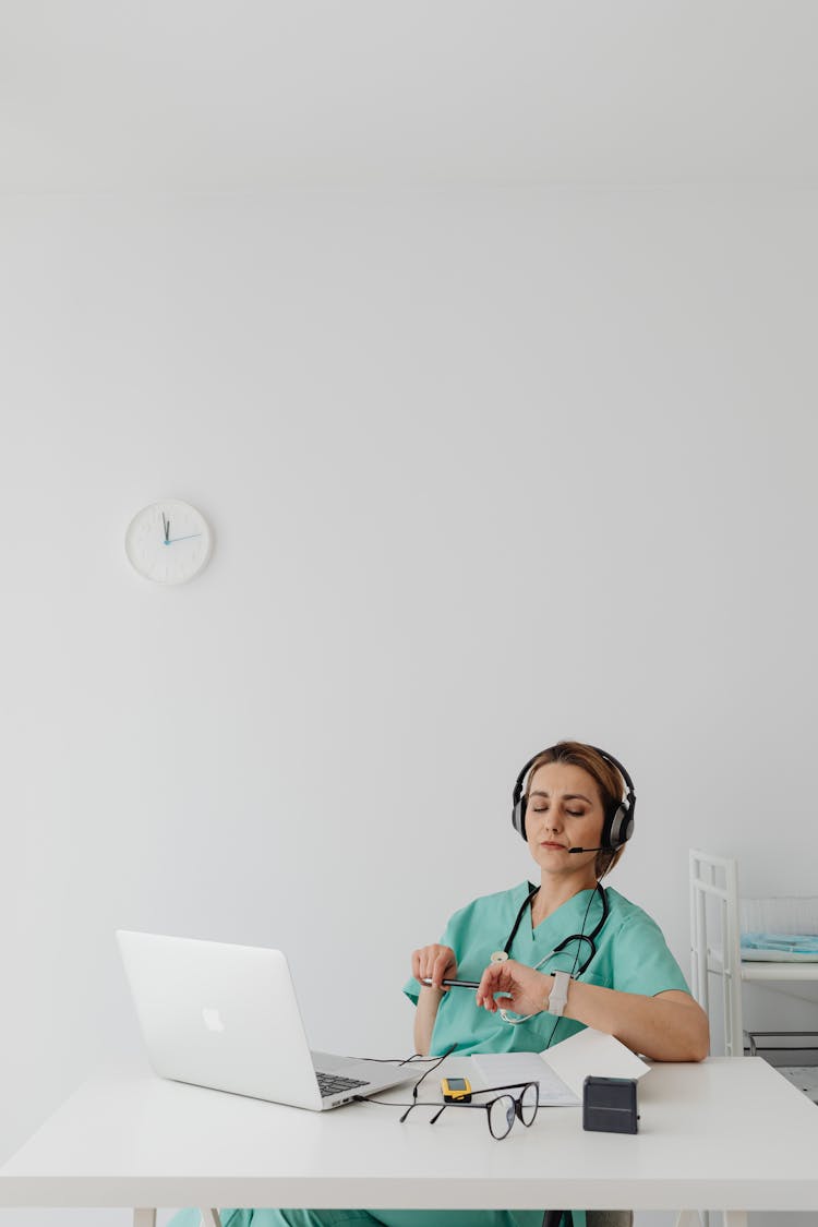 A Female Doctor Using A Laptop