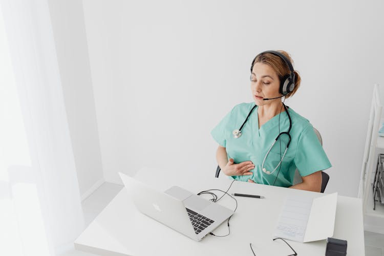 A Female Doctor Using A Laptop