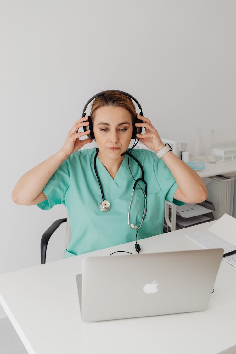 A Female Doctor Using A Laptop