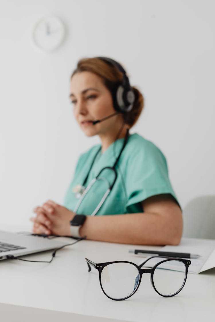 A Female Doctor Using A Laptop