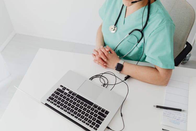 A Doctor Using A Laptop