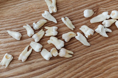Loose Teeth on a Wooden Background