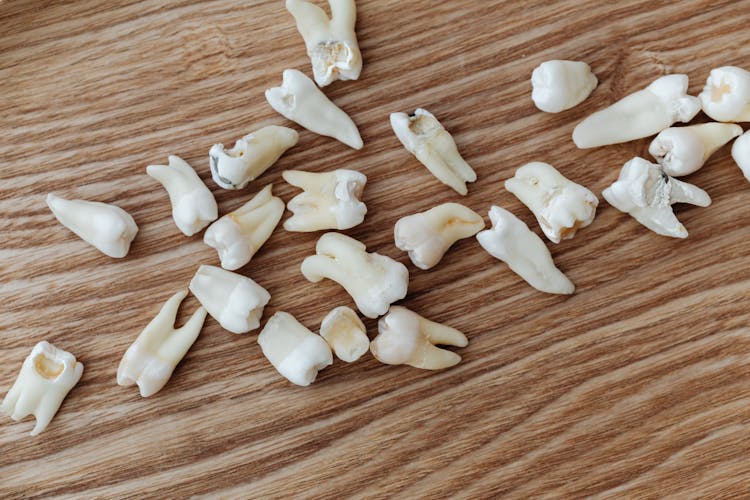 Loose Teeth On A Wooden Background