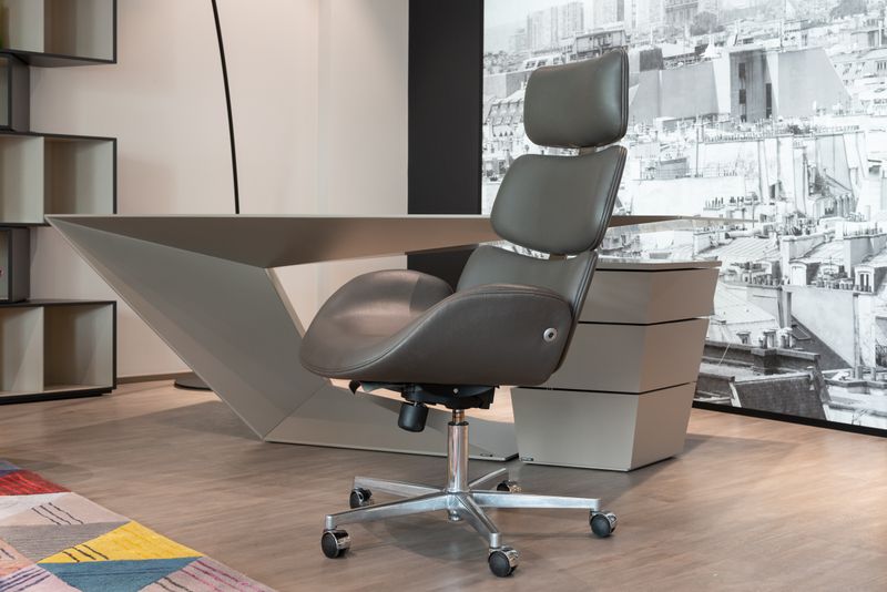 Sleek office setup with designer chair and geometric desk
