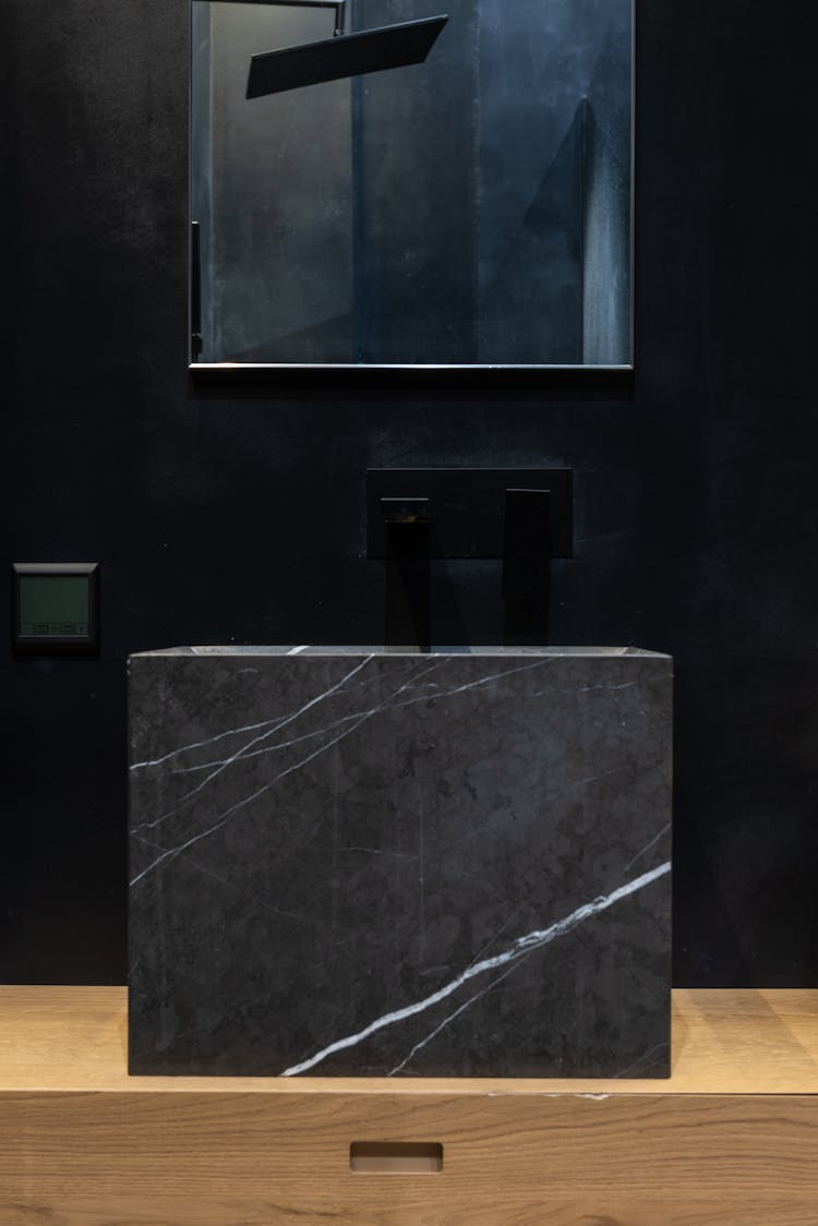 Interior Details Of Contemporary Bathroom With Marble Sink And Mirror