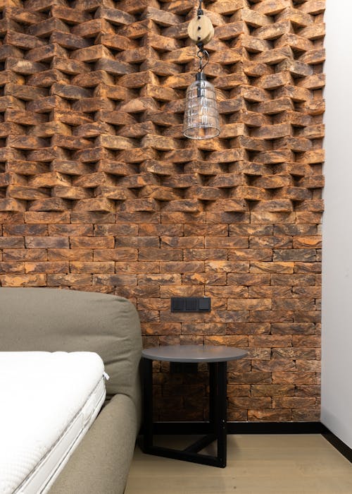 Interior details of modern loft style bedroom with creative brick wall