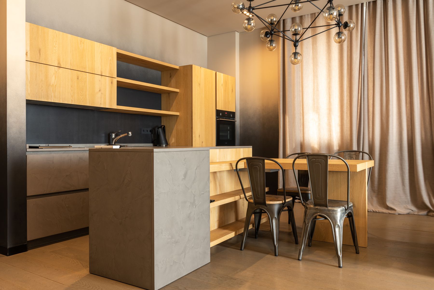 Wood and grey kitchen with a peninsula end and nearby dining table