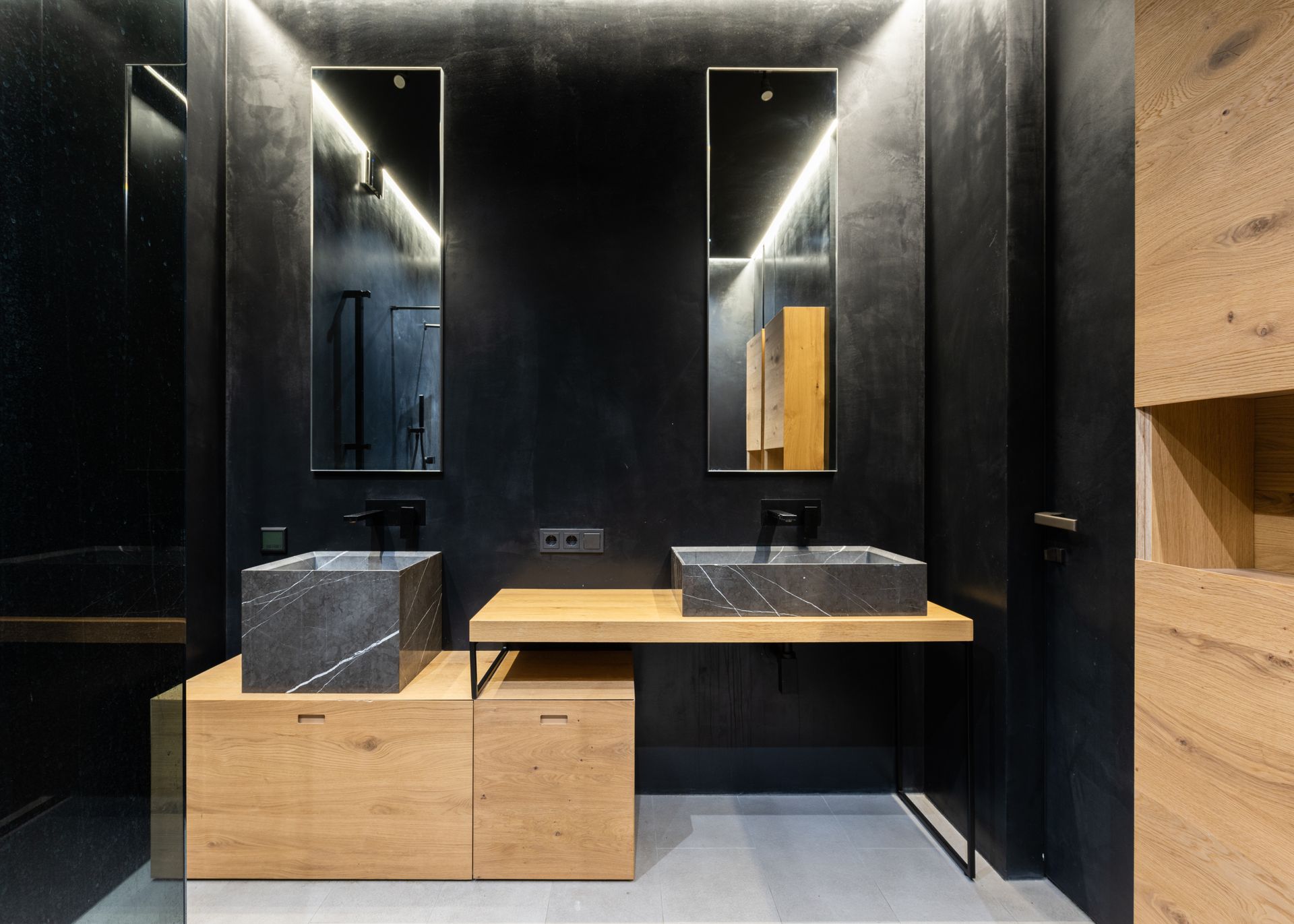Sleek bathroom design with wood and marble elements, emphasizing contemporary style.