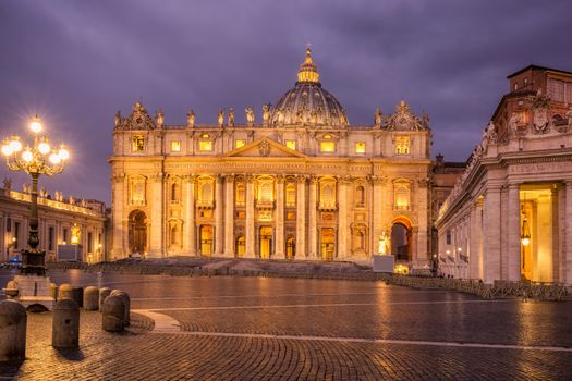St. Peter's Basilica beautifully illuminated at twilight in the Vatican City, showcasing its grandeur.