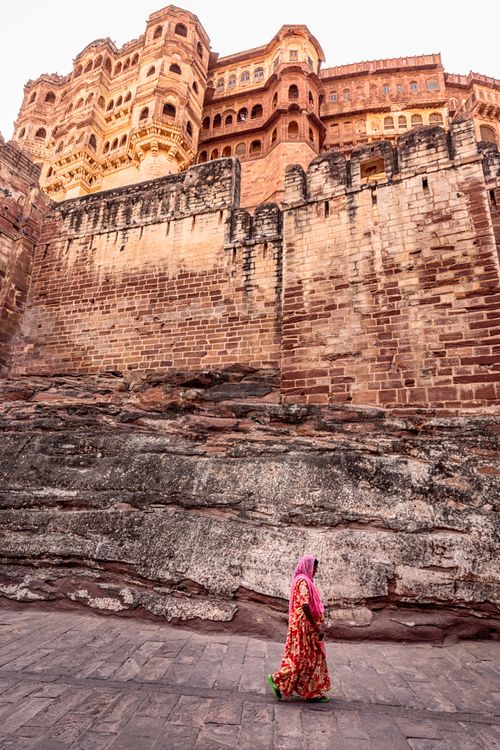 Free A woman in traditional attire walking near the historic Mehrangarh Fort in India. Stock Photo