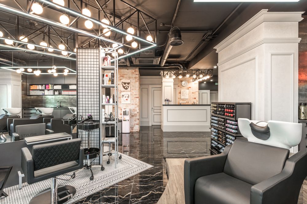 Styling stations and warm lighting inside Maison Belle salon