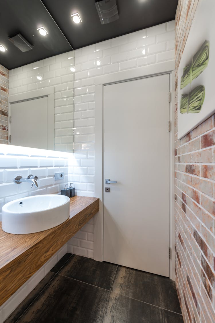 White Sink On Tope Of A Wooden Counter